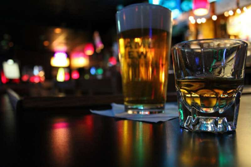 A cold beer and a shot of whiskey on the bar