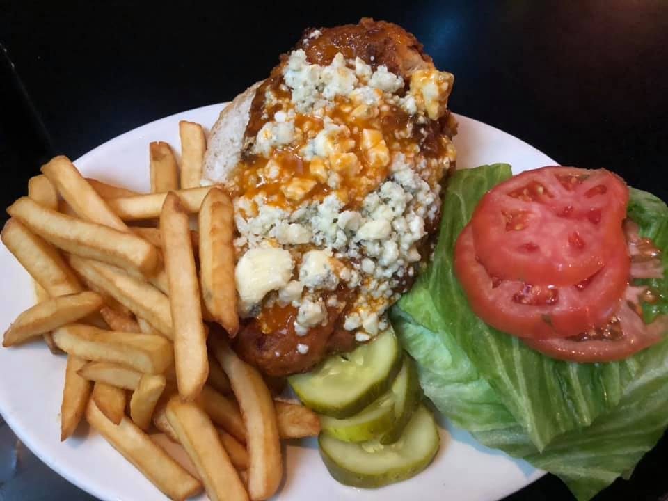 A buffalo chicken sandwich with bleu cheese, lettuce and tomato