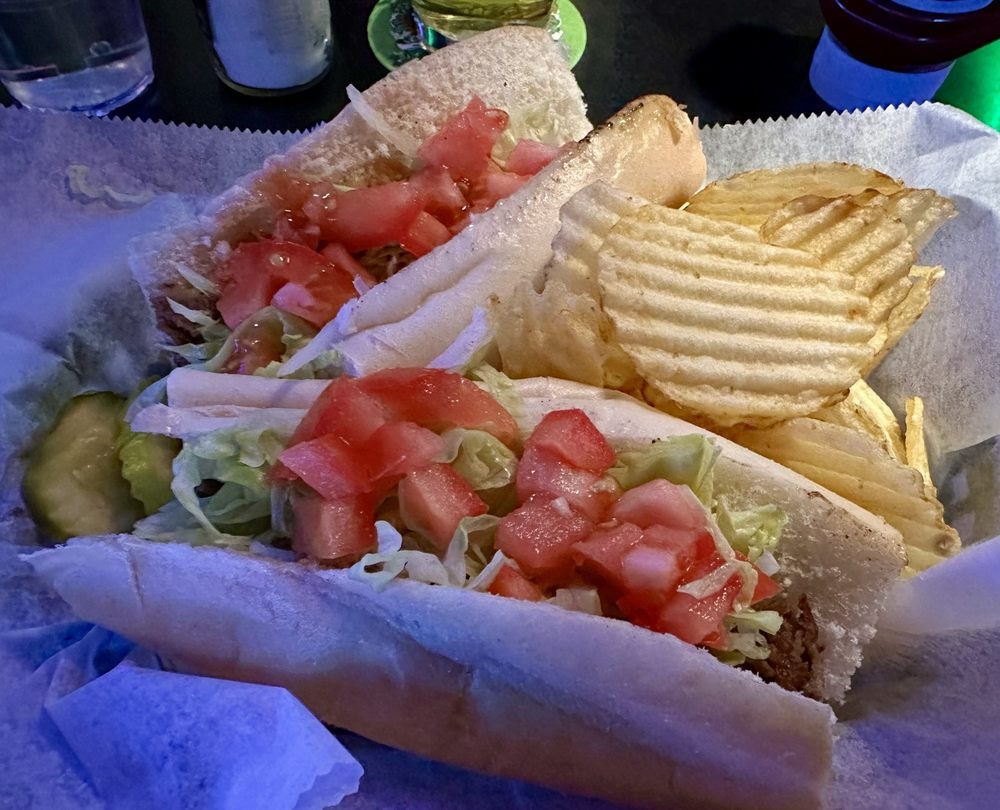 A cheesesteak hoagie with lettuce and tomato