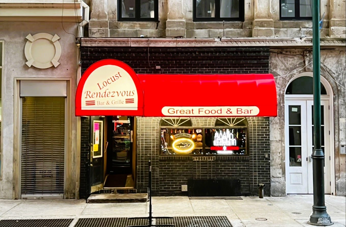 The red awning and storefront of Locust Rendezvous Bar & Grille on Locust Street